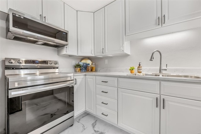 kitchen with white cabinetry, appliances with stainless steel finishes, and sink