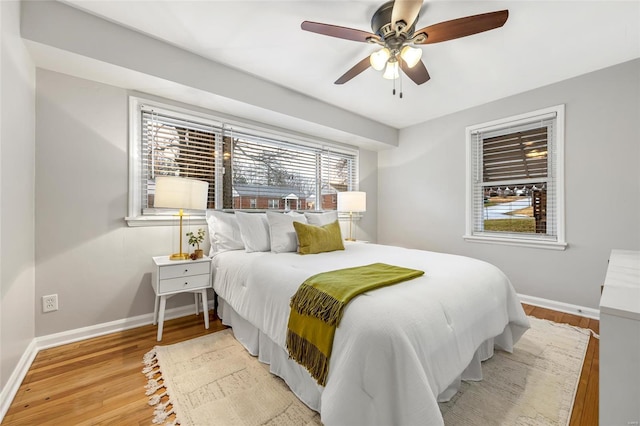 bedroom with ceiling fan and light hardwood / wood-style flooring