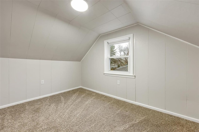 bonus room featuring lofted ceiling and carpet flooring