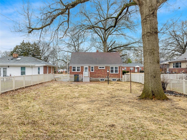 back of house with a lawn