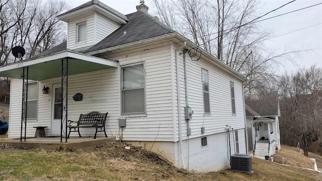 view of home's exterior with central AC unit and covered porch