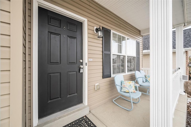 view of exterior entry with covered porch