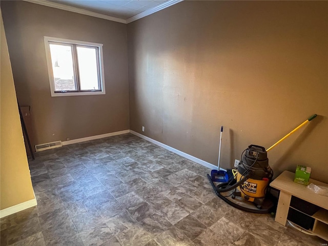 unfurnished room featuring baseboards, visible vents, and ornamental molding