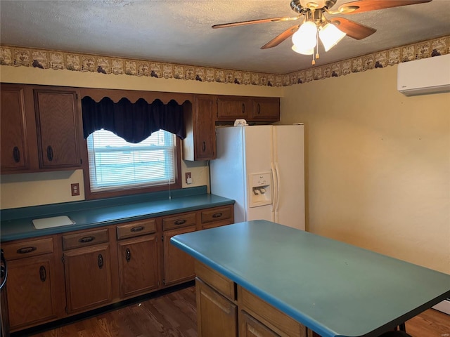 kitchen with white fridge with ice dispenser, dark wood-type flooring, a textured ceiling, and a wall unit AC