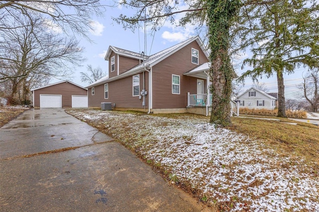 view of property exterior with cooling unit, a garage, and an outdoor structure