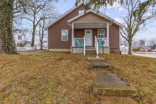 bungalow featuring a front yard and covered porch