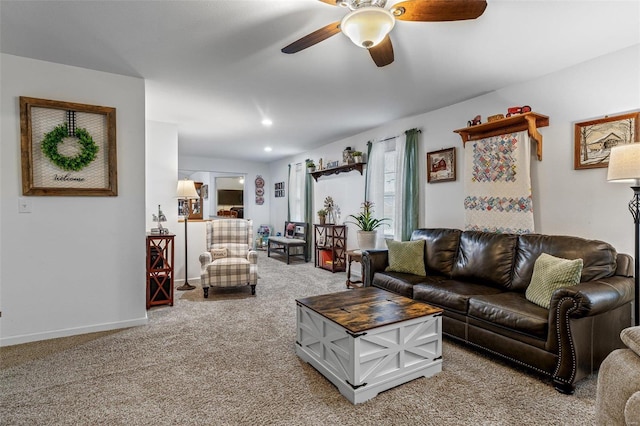 carpeted living room with ceiling fan