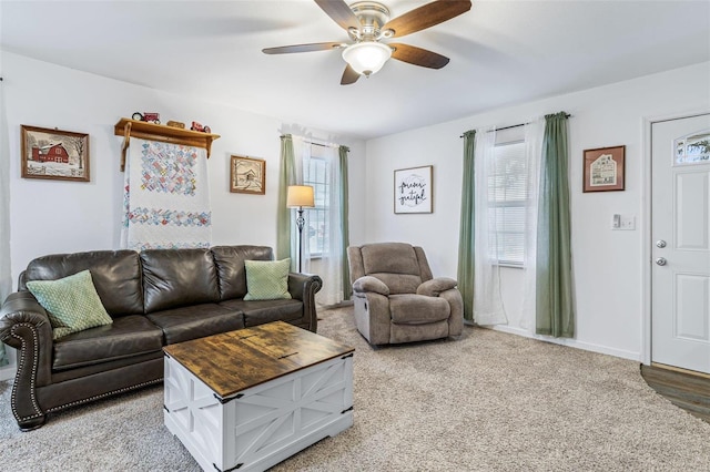 carpeted living room featuring ceiling fan