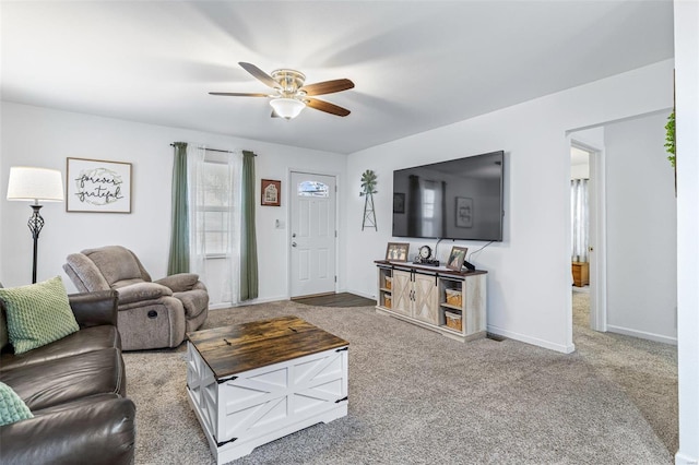 carpeted living room featuring ceiling fan