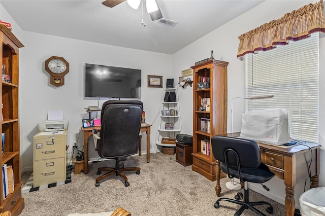 carpeted home office with ceiling fan