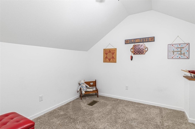 sitting room with vaulted ceiling and carpet floors