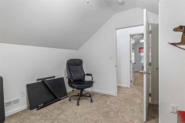 office area featuring vaulted ceiling and light carpet