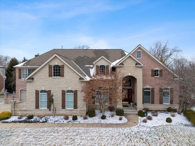 view of front of home with stone siding and brick siding