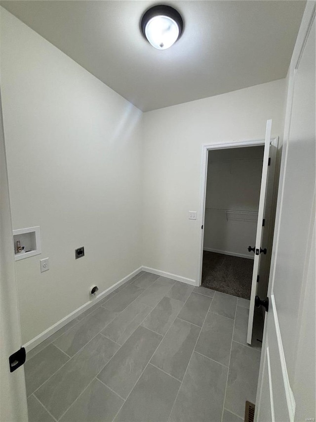 clothes washing area featuring laundry area, hookup for a washing machine, hookup for an electric dryer, and baseboards