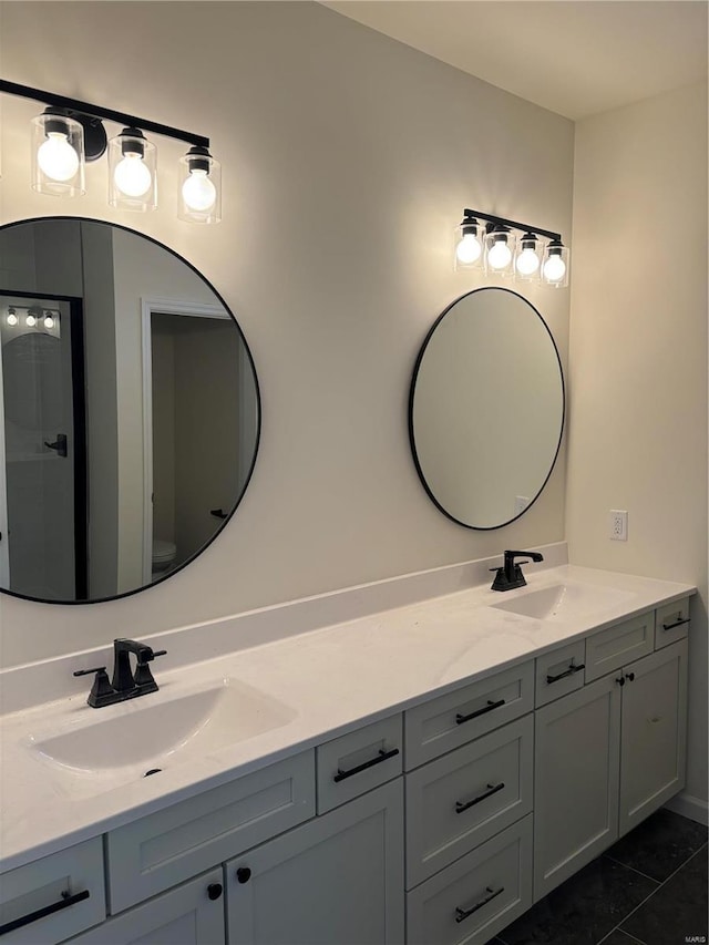 full bathroom featuring double vanity and a sink