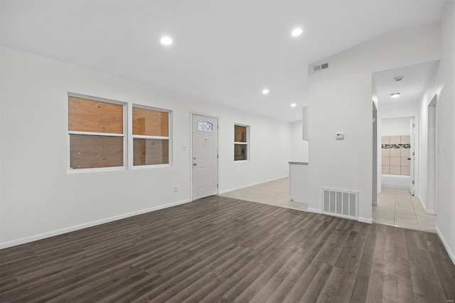 unfurnished room with visible vents, baseboards, and wood finished floors