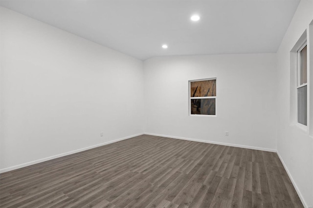 spare room with baseboards, dark wood finished floors, and recessed lighting