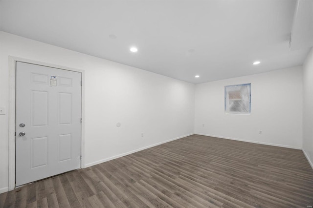 empty room featuring recessed lighting, wood finished floors, and baseboards