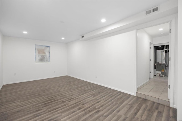 interior space with baseboards, visible vents, wood finished floors, and recessed lighting