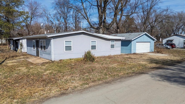 view of side of property featuring driveway and an attached garage