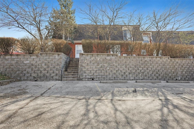 exterior space featuring stairway and fence