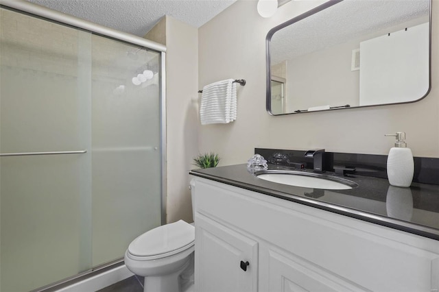 bathroom featuring visible vents, a shower stall, toilet, a textured ceiling, and vanity