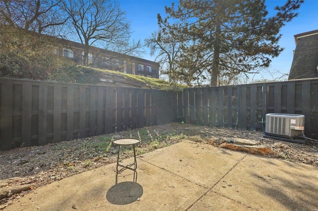 view of patio featuring central air condition unit and a fenced backyard