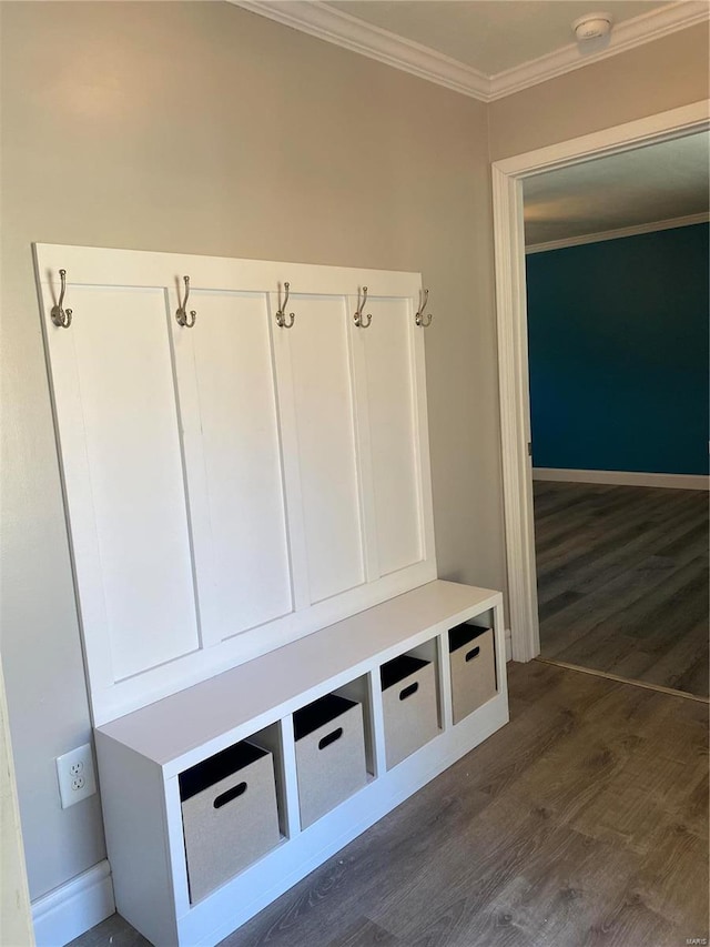 mudroom with crown molding, baseboards, and dark wood-type flooring