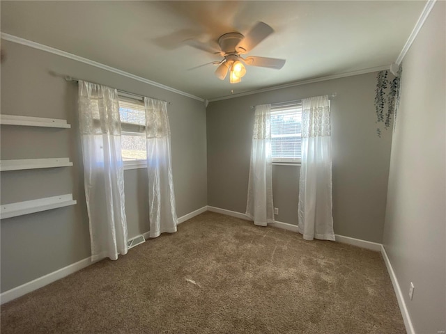 unfurnished room with a healthy amount of sunlight, ornamental molding, carpet flooring, and visible vents