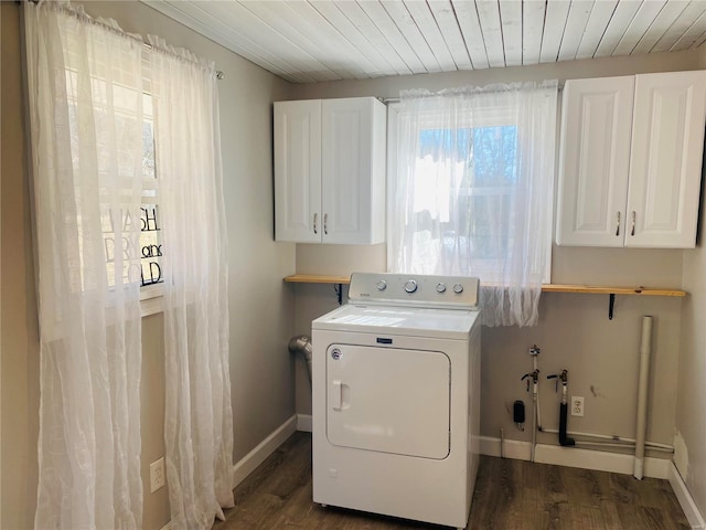 clothes washing area featuring dark wood-style flooring, baseboards, washer / clothes dryer, wood ceiling, and cabinet space