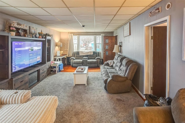 carpeted living room featuring a paneled ceiling