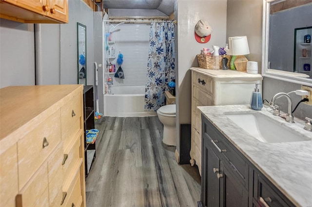 full bathroom with shower / bath combo, vanity, wood-type flooring, and toilet