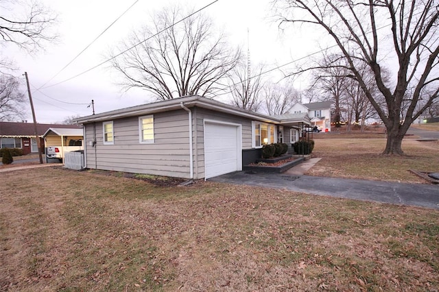 view of side of home featuring a yard and a garage