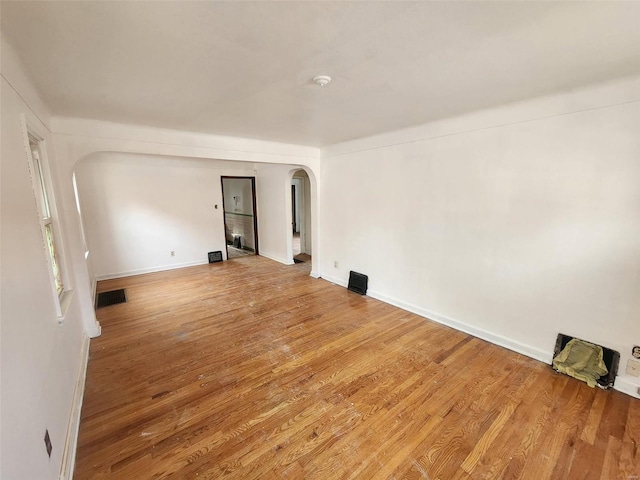 empty room with hardwood / wood-style floors