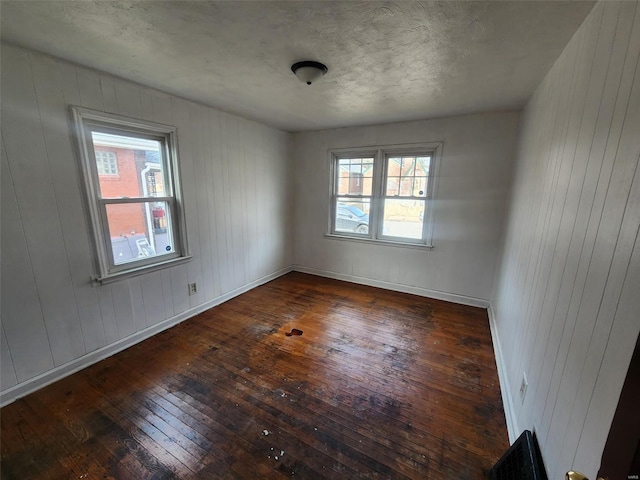 empty room featuring dark wood-type flooring