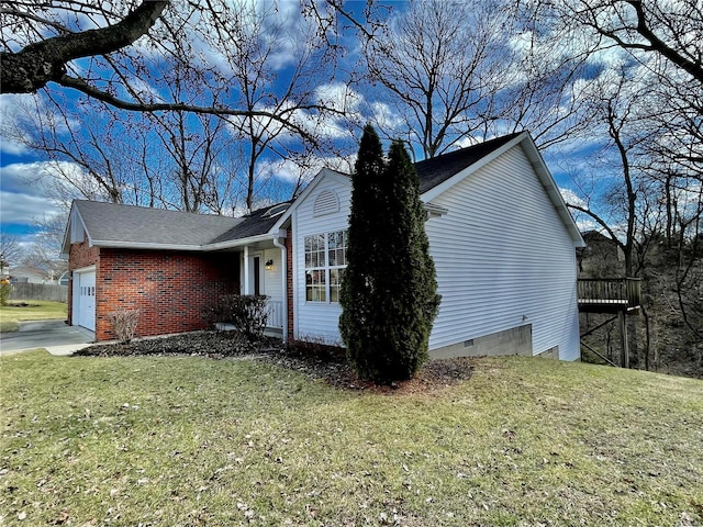 view of home's exterior featuring crawl space, a yard, an attached garage, and brick siding