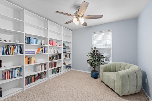 living area with carpet floors and ceiling fan