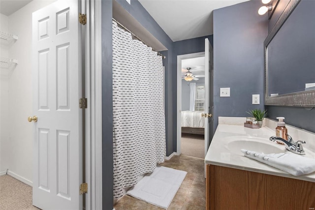 bathroom featuring vanity, ceiling fan, and walk in shower