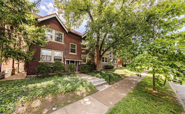 view of front of home featuring brick siding