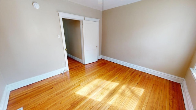 unfurnished bedroom featuring baseboards and hardwood / wood-style floors