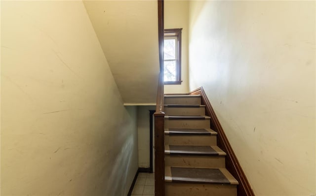 stairway featuring tile patterned flooring