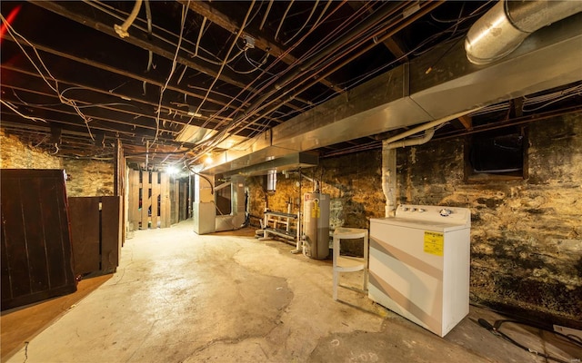 unfinished below grade area featuring washer / clothes dryer, water heater, and heating unit