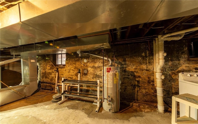 unfinished basement featuring water heater and washer / dryer