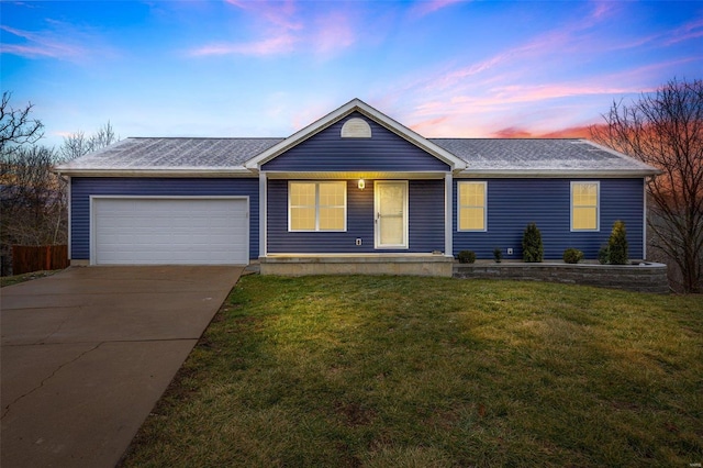 single story home featuring a yard and a garage