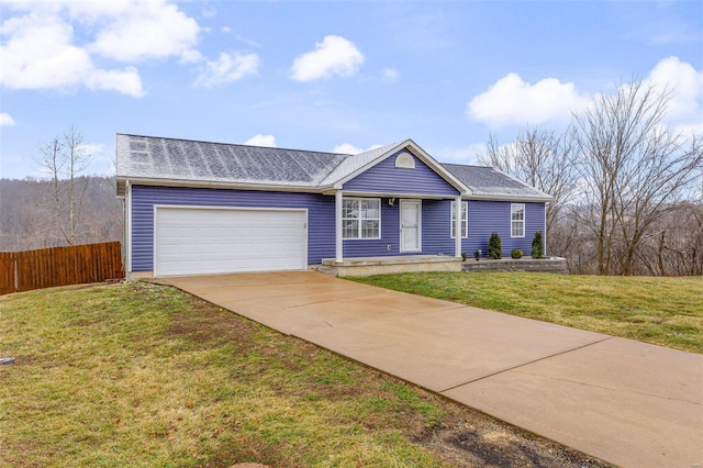 ranch-style home featuring a garage and a front yard