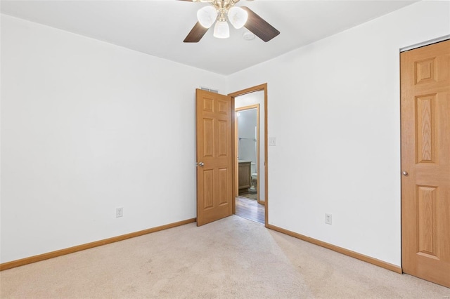 empty room featuring light colored carpet and ceiling fan