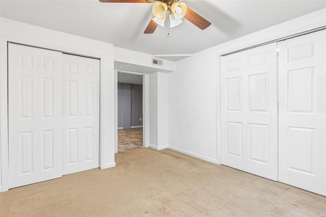 unfurnished bedroom with light carpet, ceiling fan, and a closet