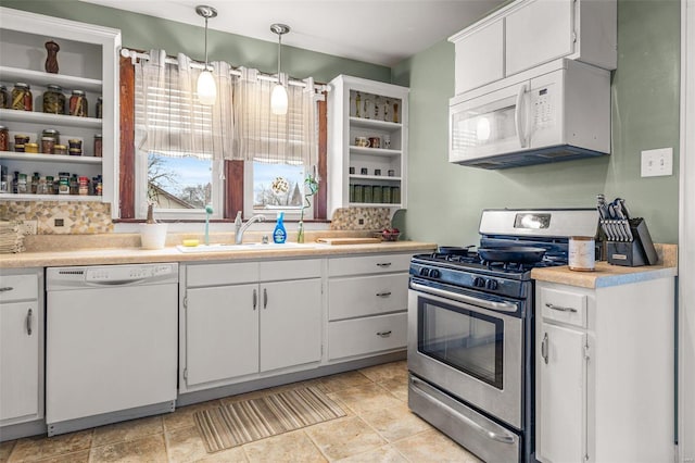 kitchen with pendant lighting, white cabinetry, sink, backsplash, and white appliances