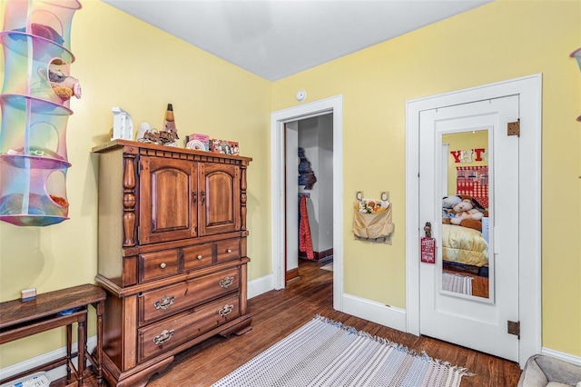 bedroom with dark wood-type flooring