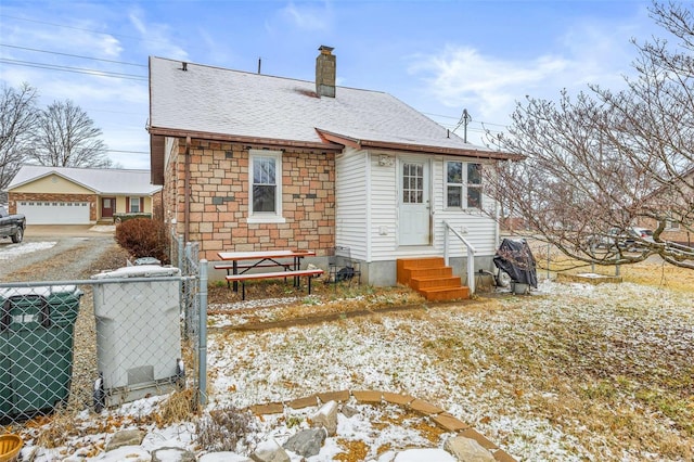 snow covered property featuring a garage